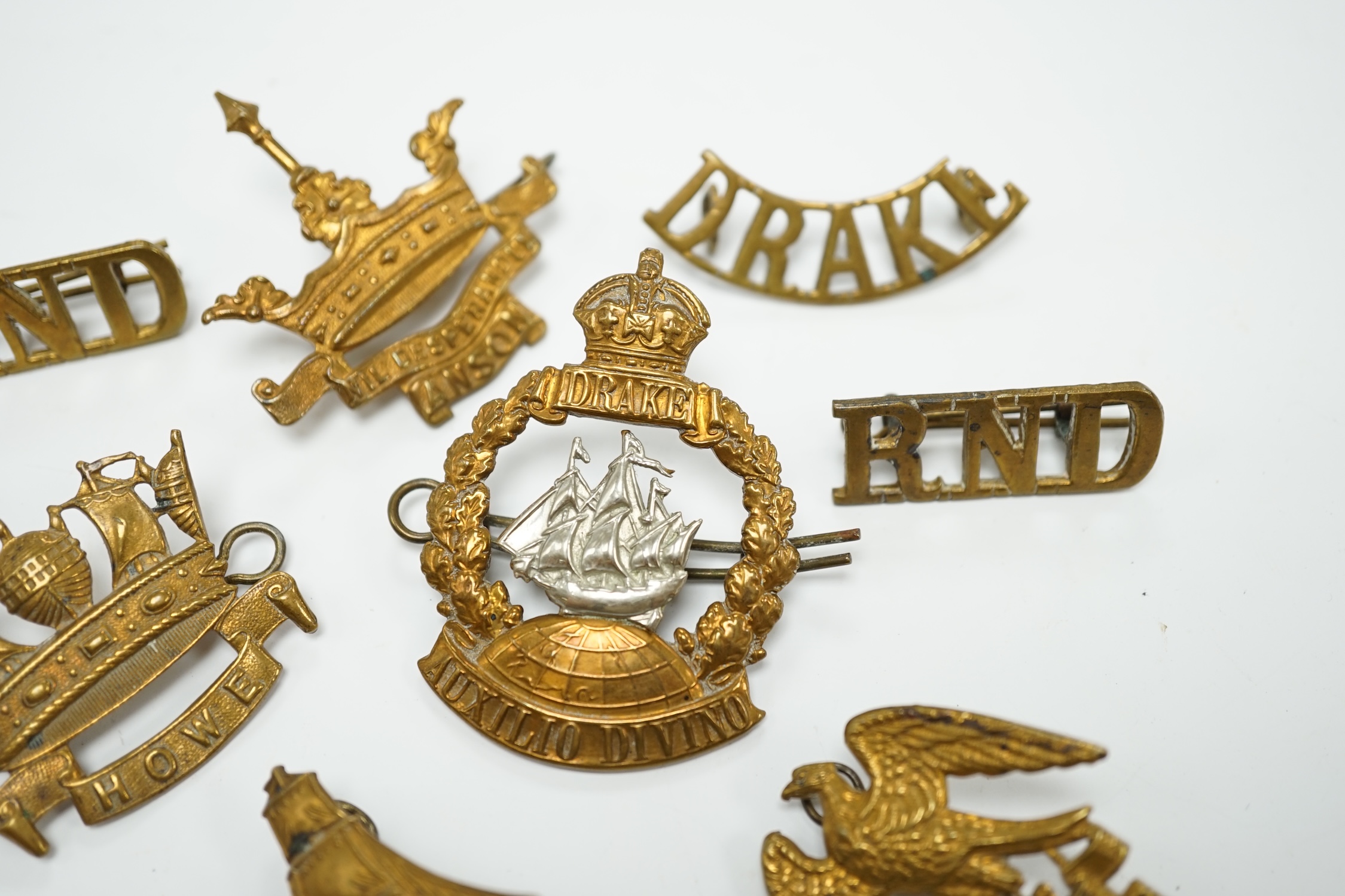 Five Royal Navy First World War brass cap badges; the Nelson, Hawke, Anson and Howe Battalions, together with three shoulder titles. Condition - fair, some possible restrikes.